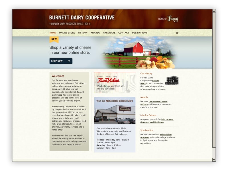 Burnett Dairy Cooperative website with a wood-textured header, barn and cheese imagery, and three columns of content.